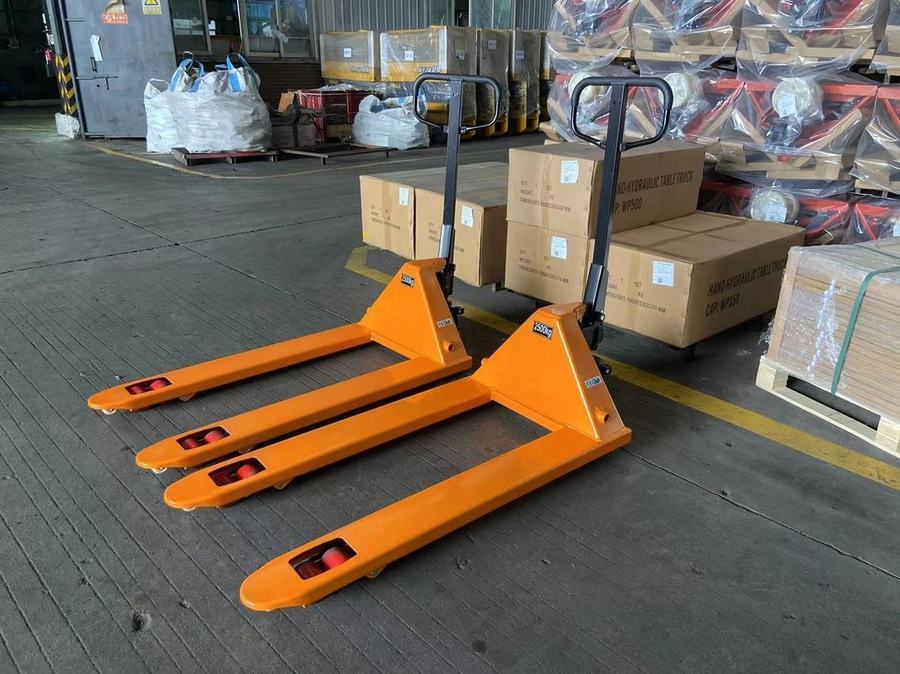 Manual pallet trucks staged in warehouse