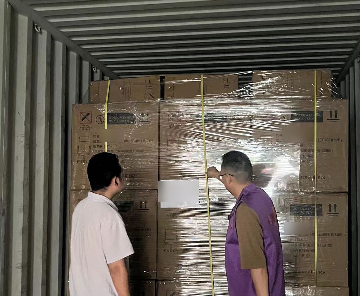 HOSON staff reviewing palletized products during container loading